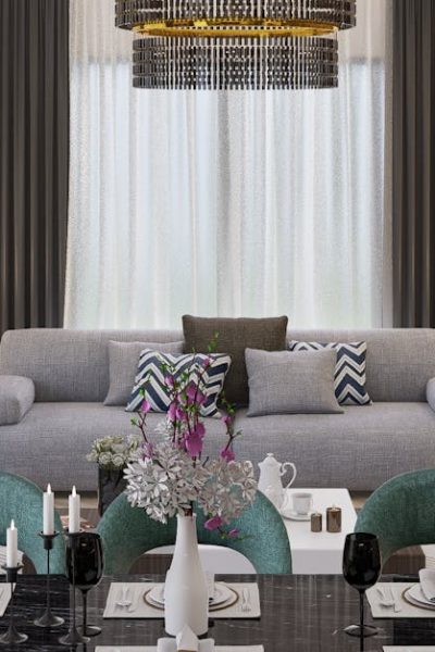 Contemporary open plan living room with sleek furniture and a dining area, showcasing stylish interior design.