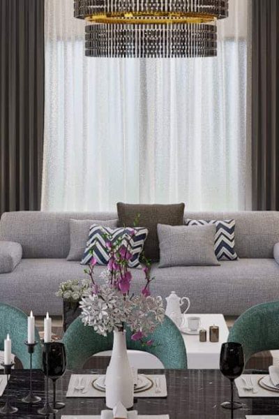 Contemporary open plan living room with sleek furniture and a dining area, showcasing stylish interior design.
